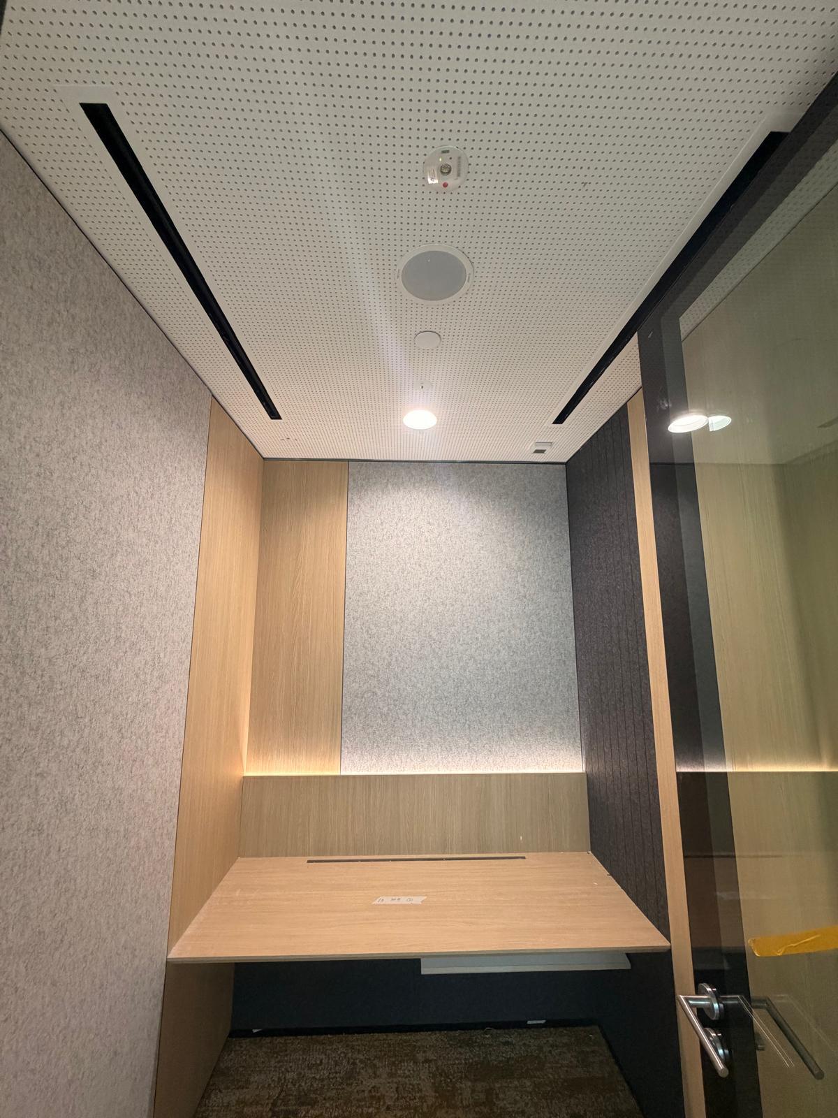 Focus room with perforated ceiling, linear lighting, speaker and smoke detector installation in Singapore office