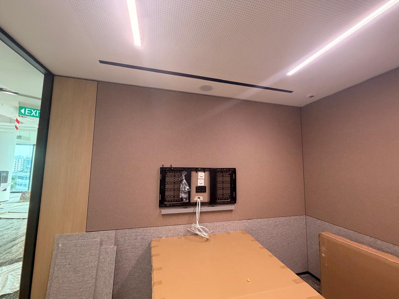 Meeting room wall with TV bracket, data points and power sockets prepared for AV installation