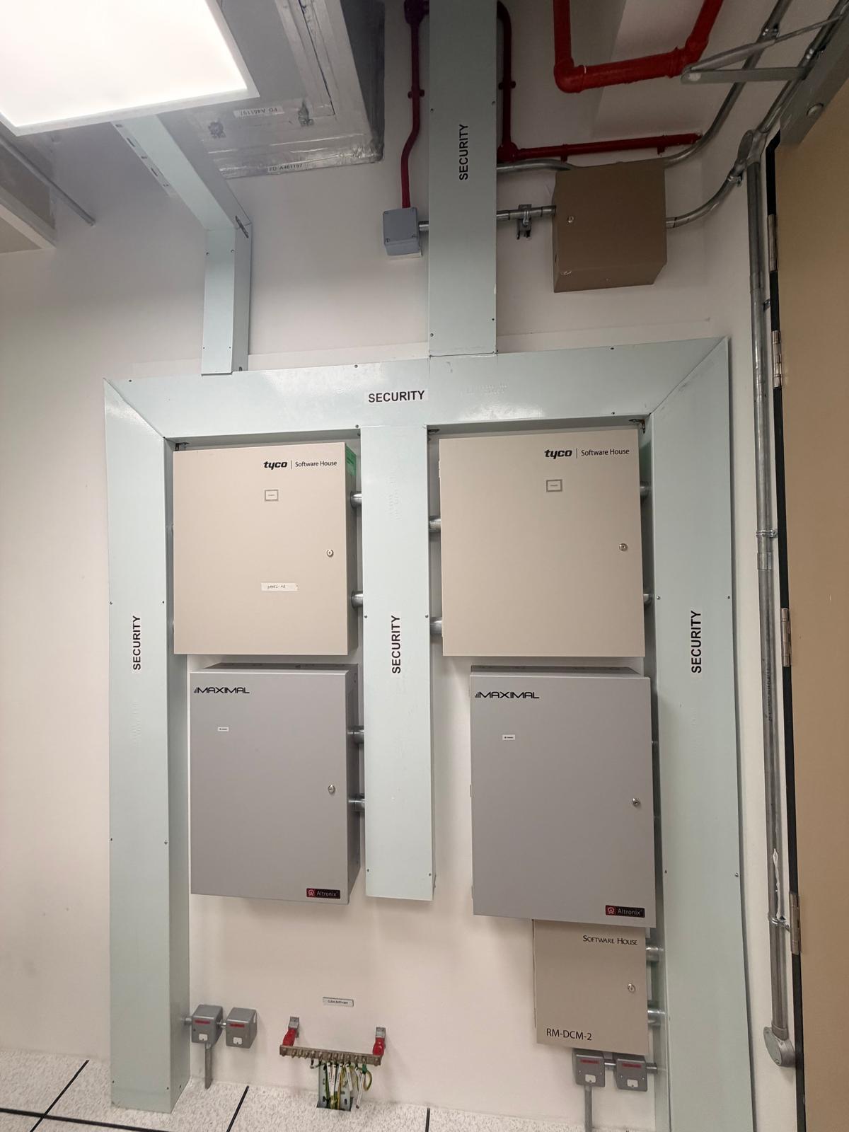 Tyco Software House access control panels with Altronix power supplies and conduit containment — security system installation Singapore